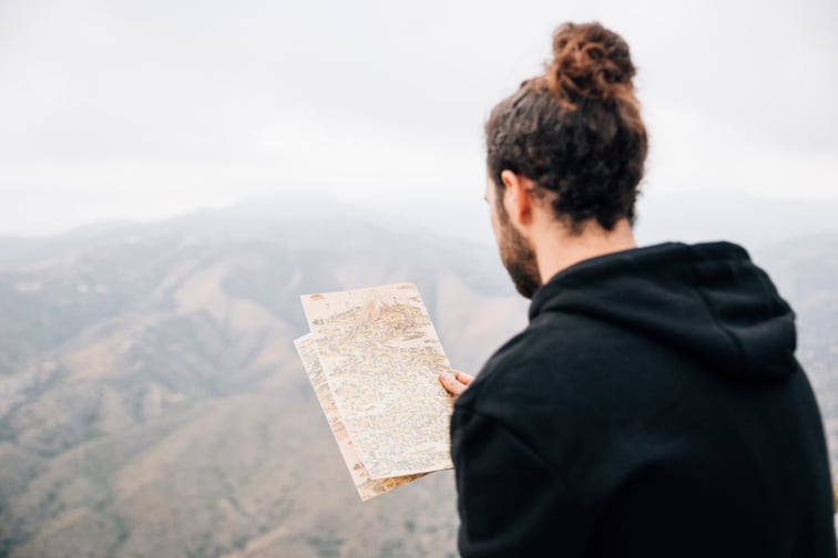 close-up-male-hiker-reading-map