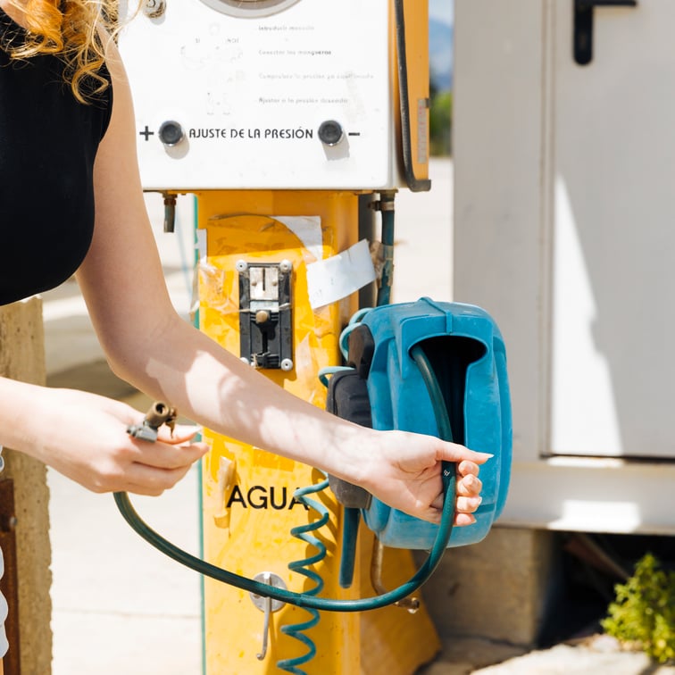 crop-female-holding-inflator-service-station