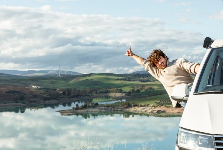 front-view-happy-man-enjoying-nature-while-road-trip
